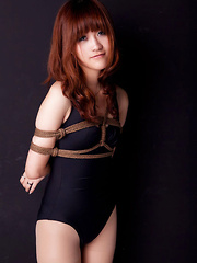 Lala Asian babe in bath suit has hands tied of her boobs in ropes